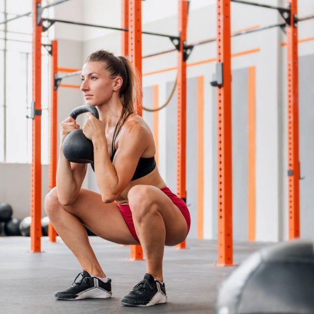 Woman performing a goblet squat at the gym.