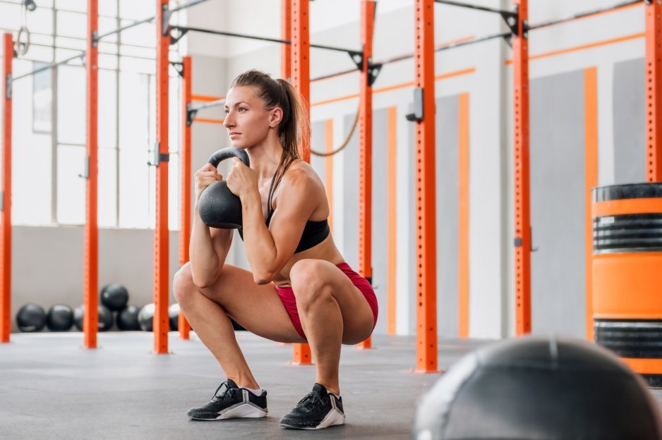 Woman performing a goblet squat at the gym.