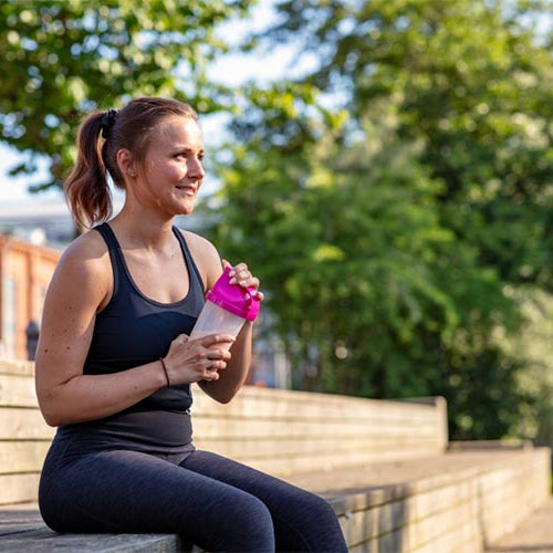 Woman drinking a protein shake.